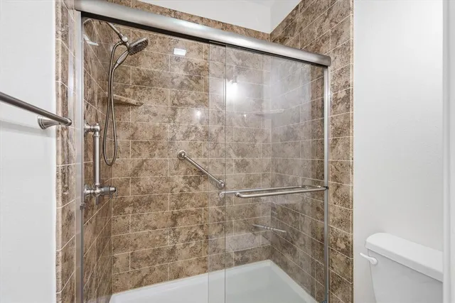 a bedroom with a large bed and a chandelier