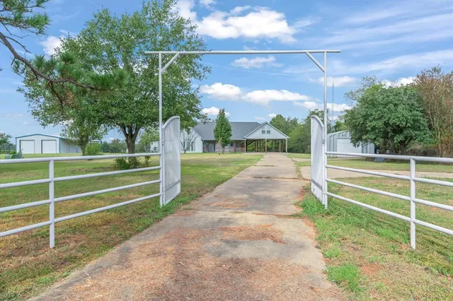 a view of a house with a yard and porch