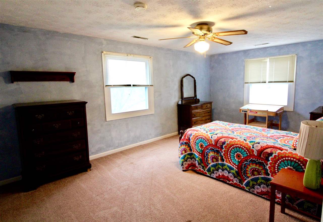 31 West Roman Ridge Road Mount Sidney, VA 24467 - Photo 16 of 23 a bedroom with a bed and a chandelier