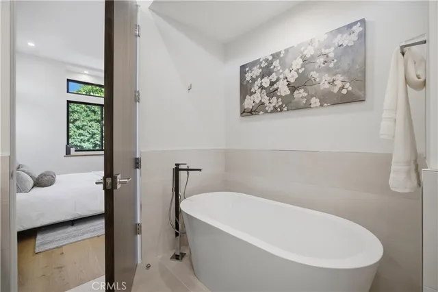 a white bath tub sitting next to a white toilet