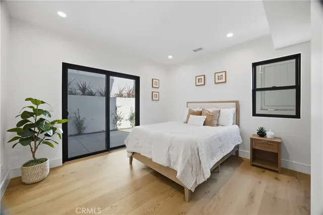 a bedroom with a bed and a large mirror