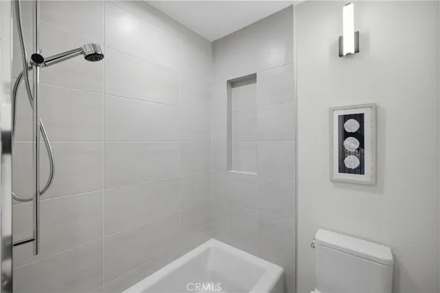 a view of a bedroom with furniture and window