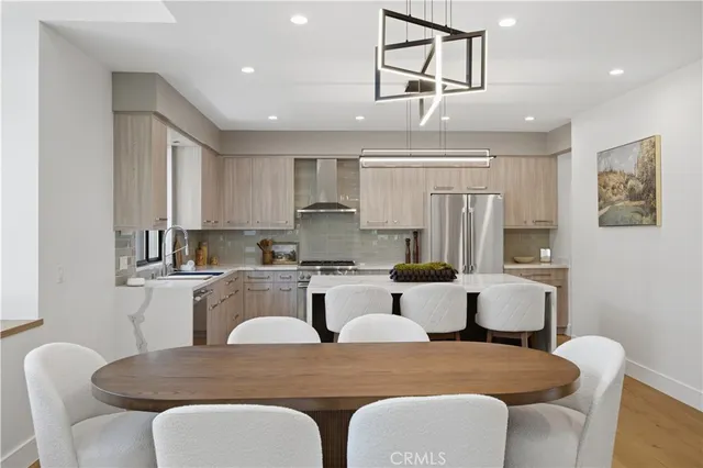 a large kitchen with a table and chairs