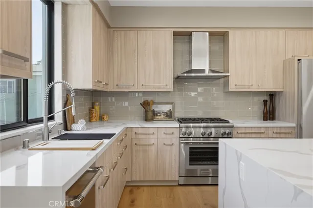 a kitchen with granite countertop a sink stainless steel appliances and cabinets