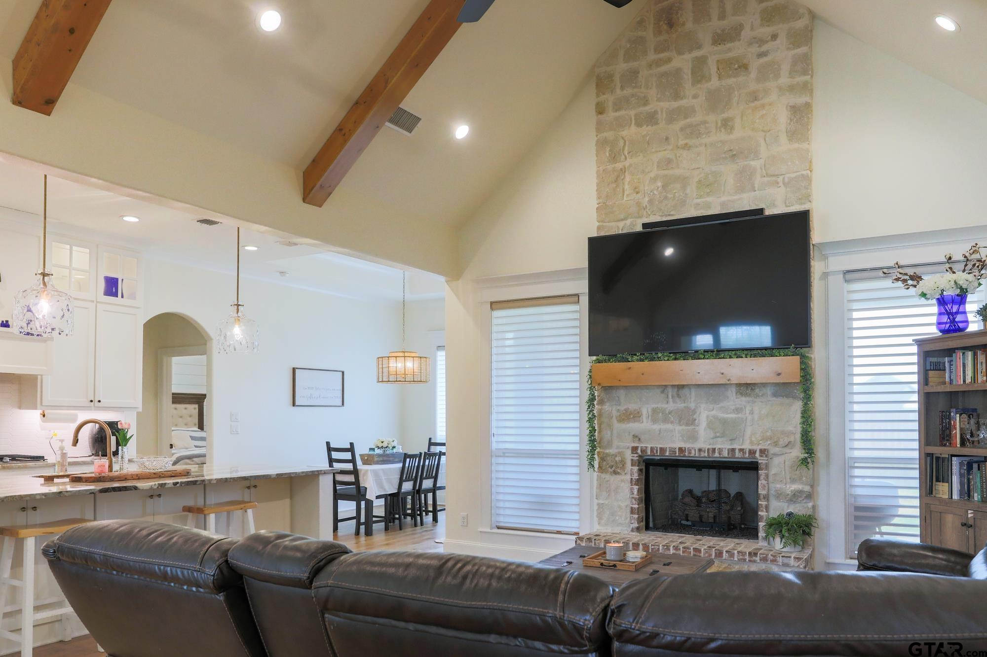 9065 Shallow Cove Tyler, TX 75703 - Photo 11 of 40 a living room with furniture a flat screen tv and a fireplace