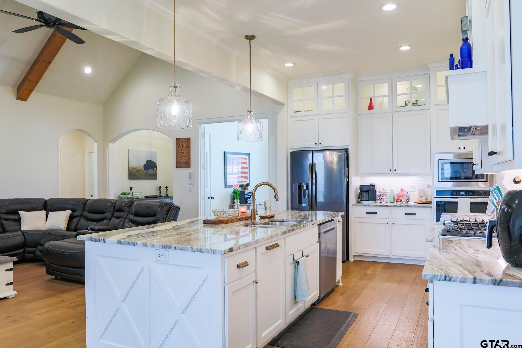 9065 Shallow Cove Tyler, TX 75703 - Photo 16 of 40 a kitchen with refrigerator and cabinets