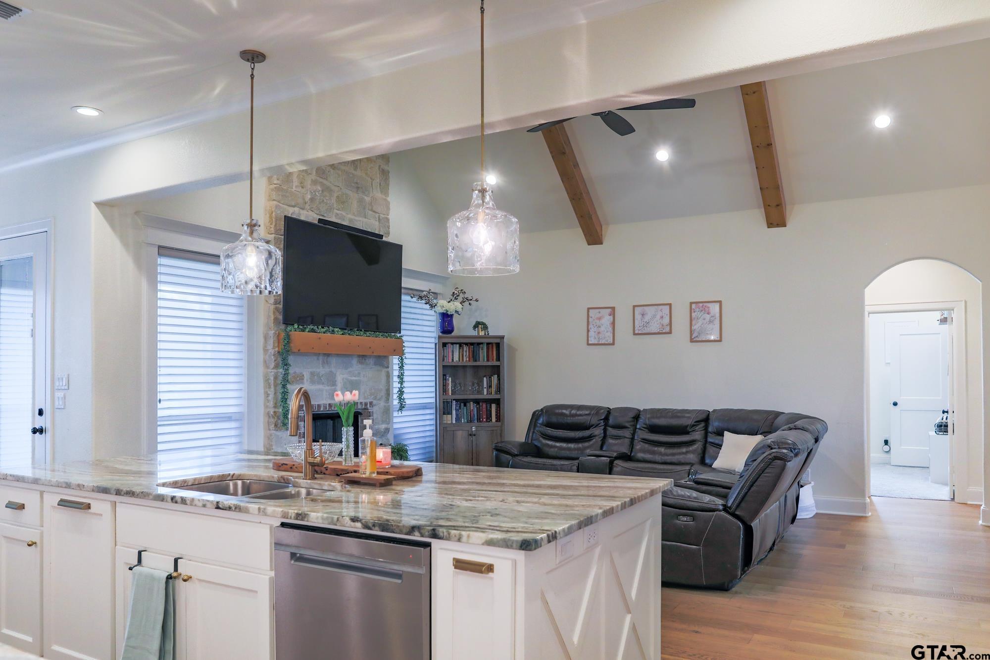 9065 Shallow Cove Tyler, TX 75703 - Photo 20 of 40 a kitchen with stainless steel appliances granite countertop a sink a stove and a wooden floors