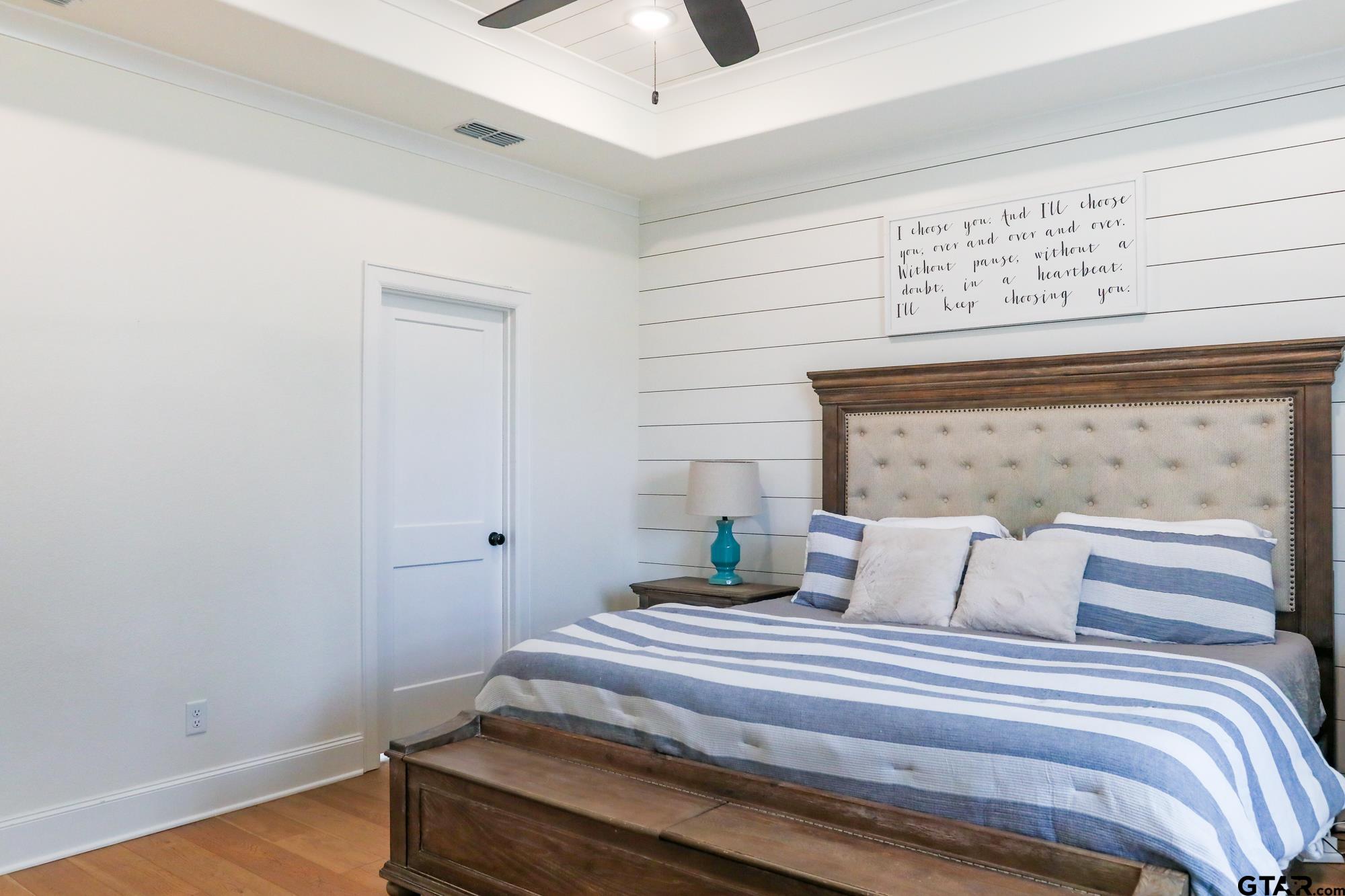 9065 Shallow Cove Tyler, TX 75703 - Photo 24 of 40 a bedroom with a bed and wooden floor