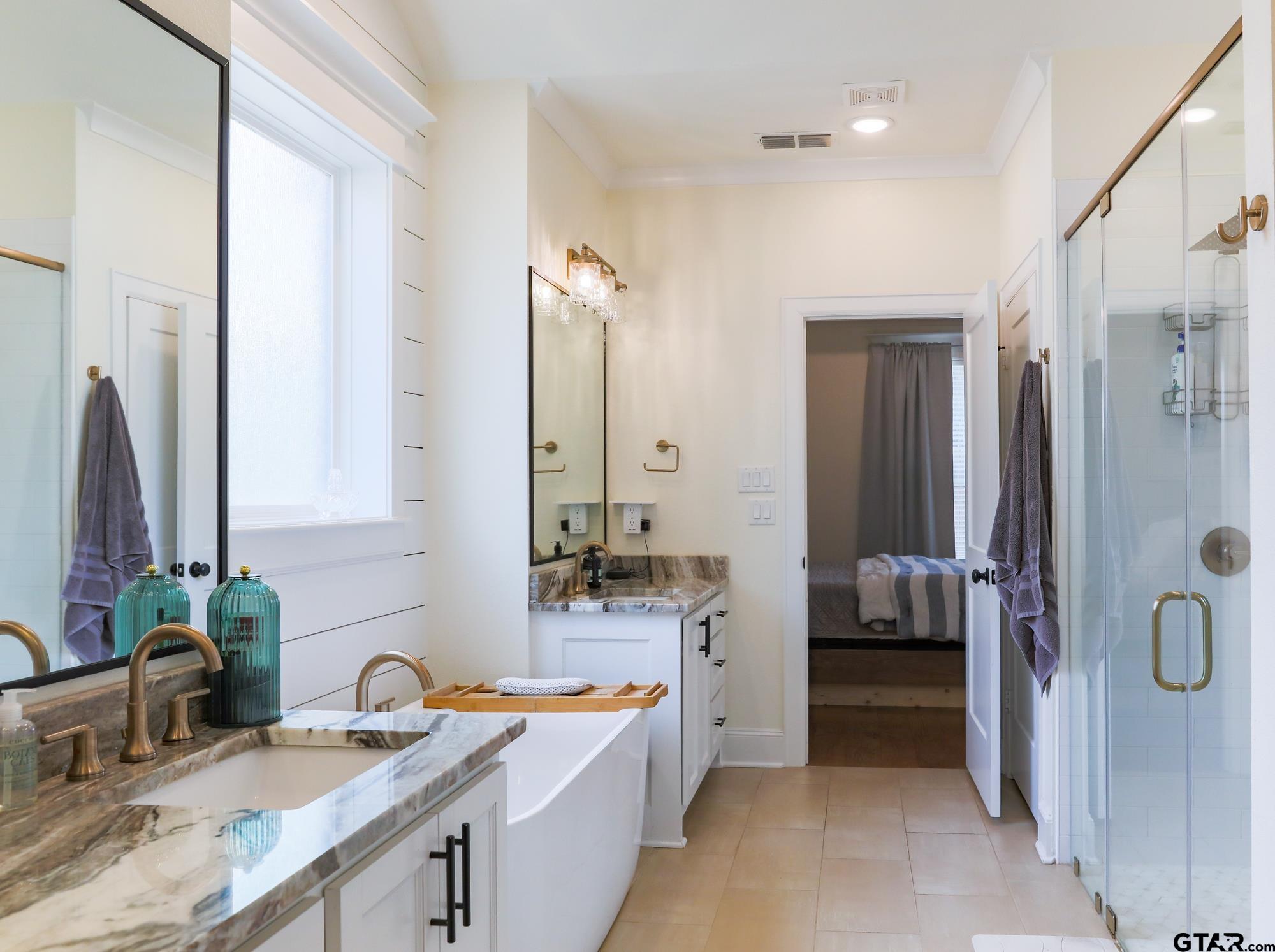 9065 Shallow Cove Tyler, TX 75703 - Photo 26 of 40 a bathroom with a sink double vanity and shower