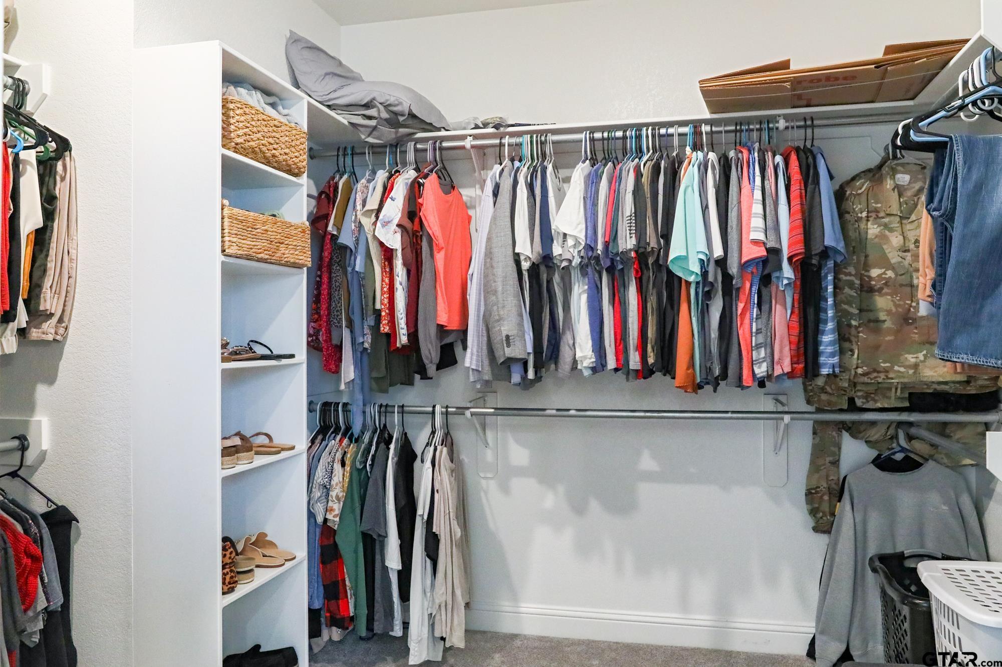 9065 Shallow Cove Tyler, TX 75703 - Photo 28 of 40 a view of walk in closet with clothes and shoes