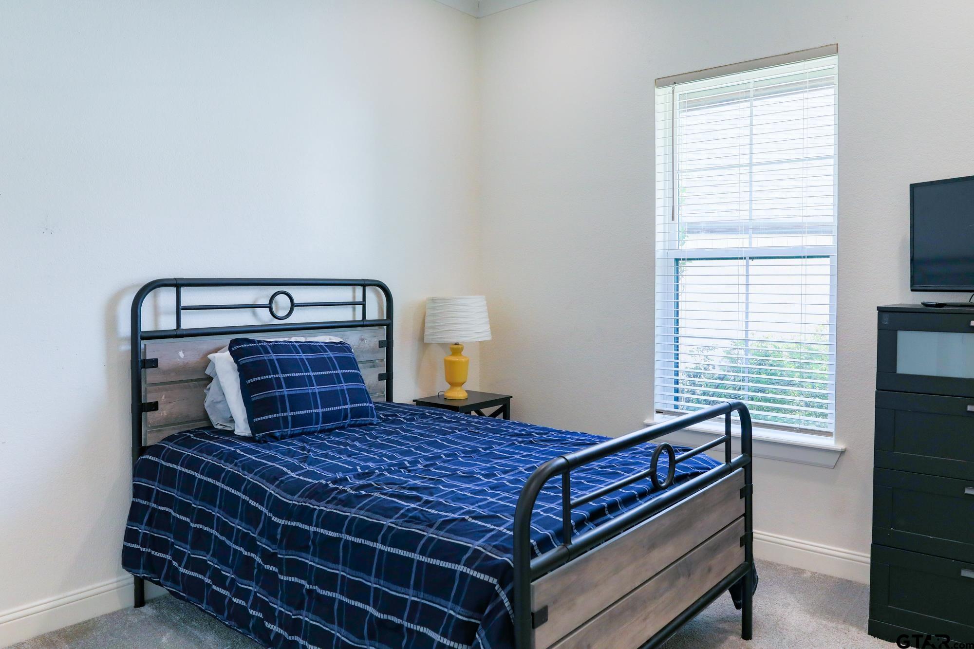 9065 Shallow Cove Tyler, TX 75703 - Photo 32 of 40 a bedroom with a bed and window