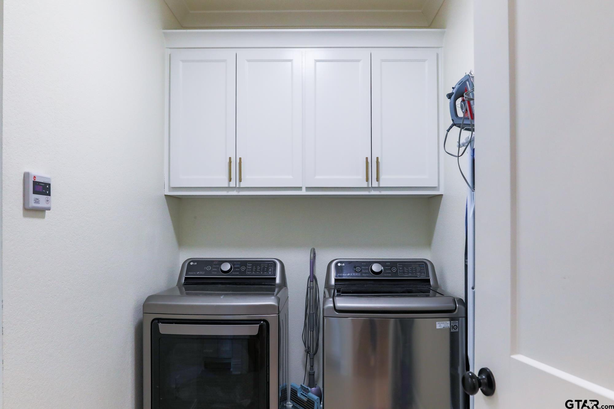 9065 Shallow Cove Tyler, TX 75703 - Photo 37 of 40 a kitchen with a stove and a microwave