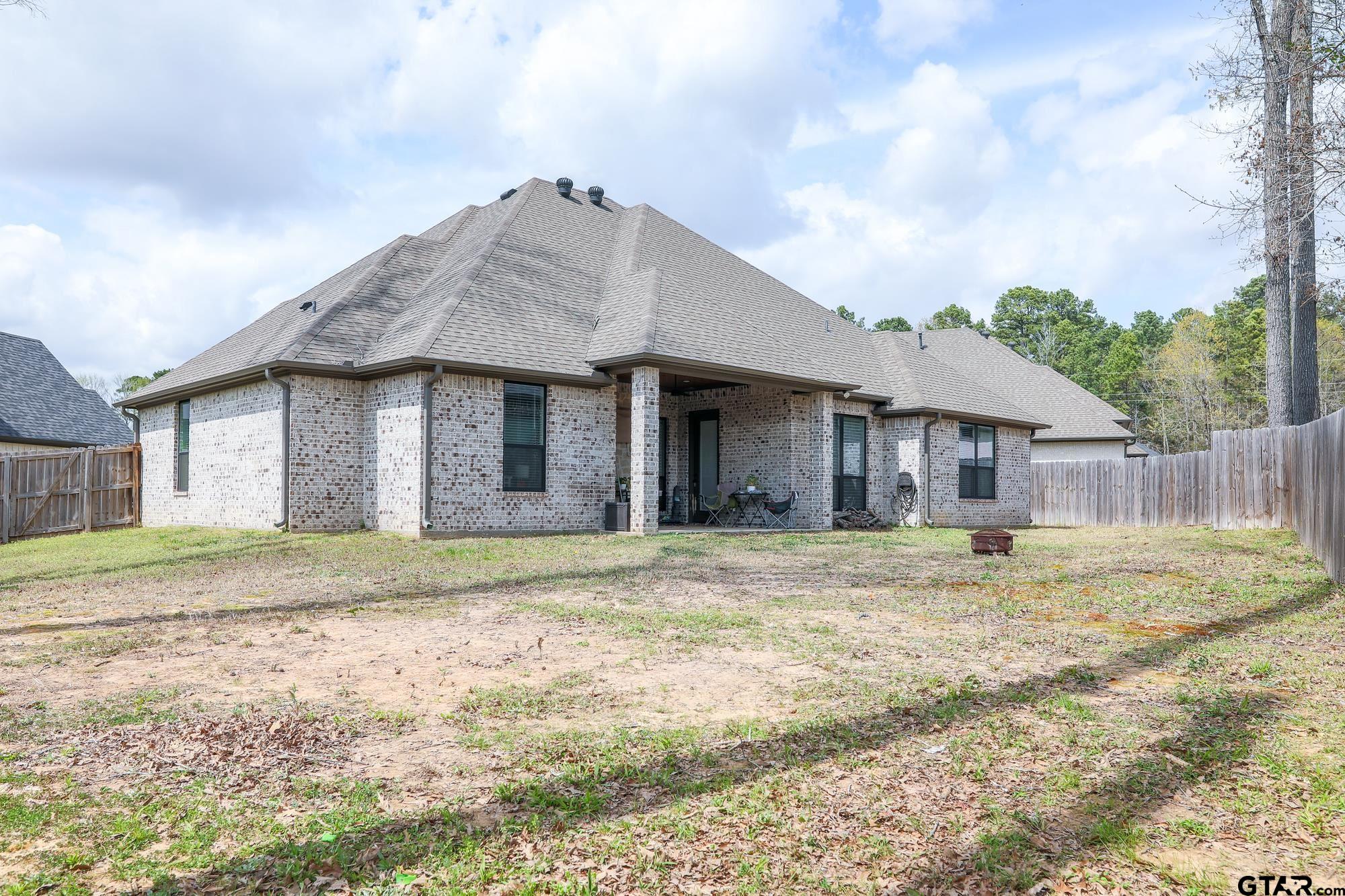 9065 Shallow Cove Tyler, TX 75703 - Photo 38 of 40 a view of a house with a yard and wooden fence