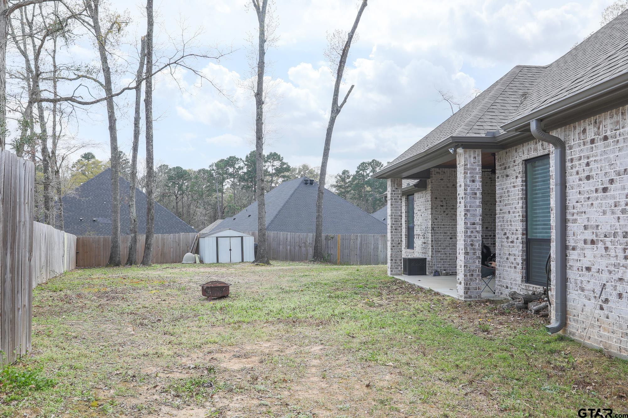 9065 Shallow Cove Tyler, TX 75703 - Photo 39 of 40 a white house that has a tree in front of it
