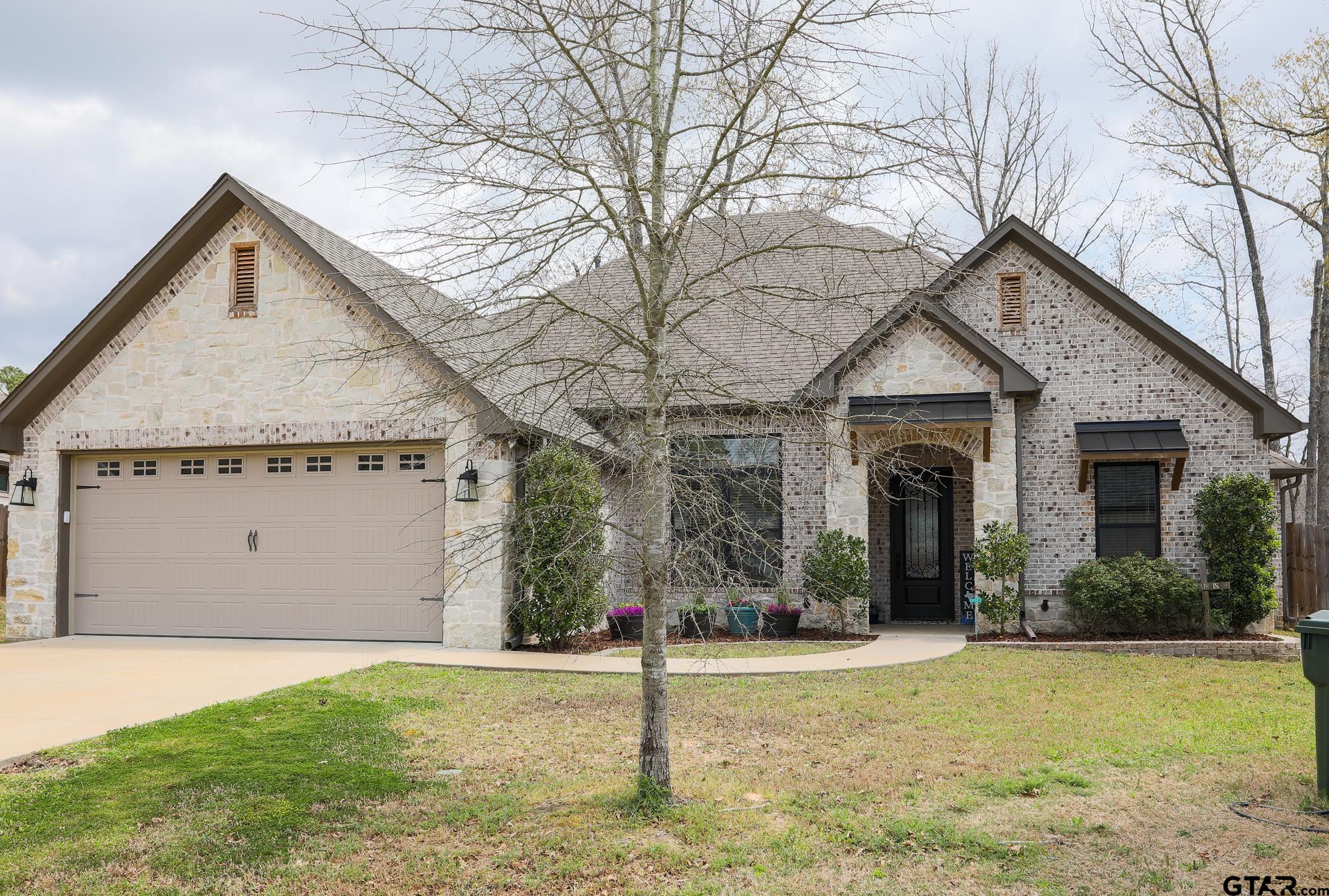 9065 Shallow Cove Tyler, TX 75703 - Photo 5 of 40 a view of a house with a yard and potted plants