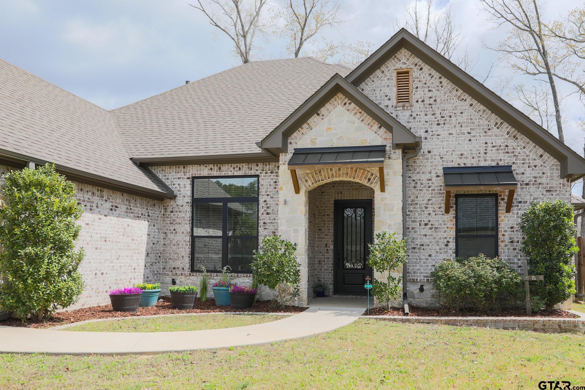 9065 Shallow Cove Tyler, TX 75703 - Photo 6 of 40 a front view of a house with garden