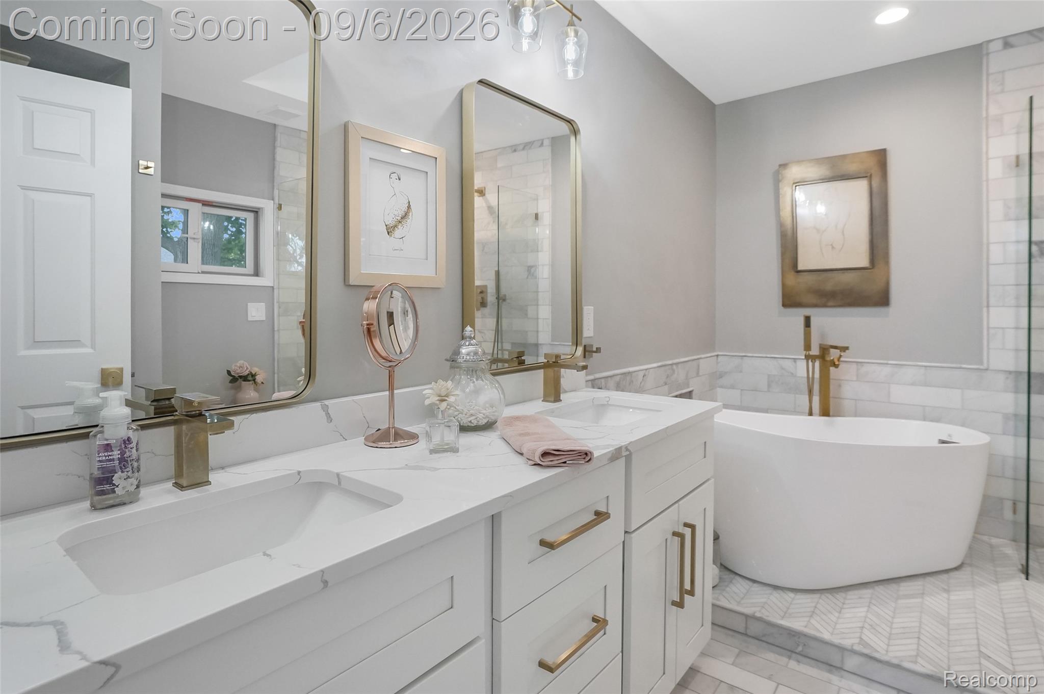 13203 Log Cabin Point Fenton, MI 48430 - Photo 23 of 55 Dual vanity with white cabinetry and gold-tone hardware
