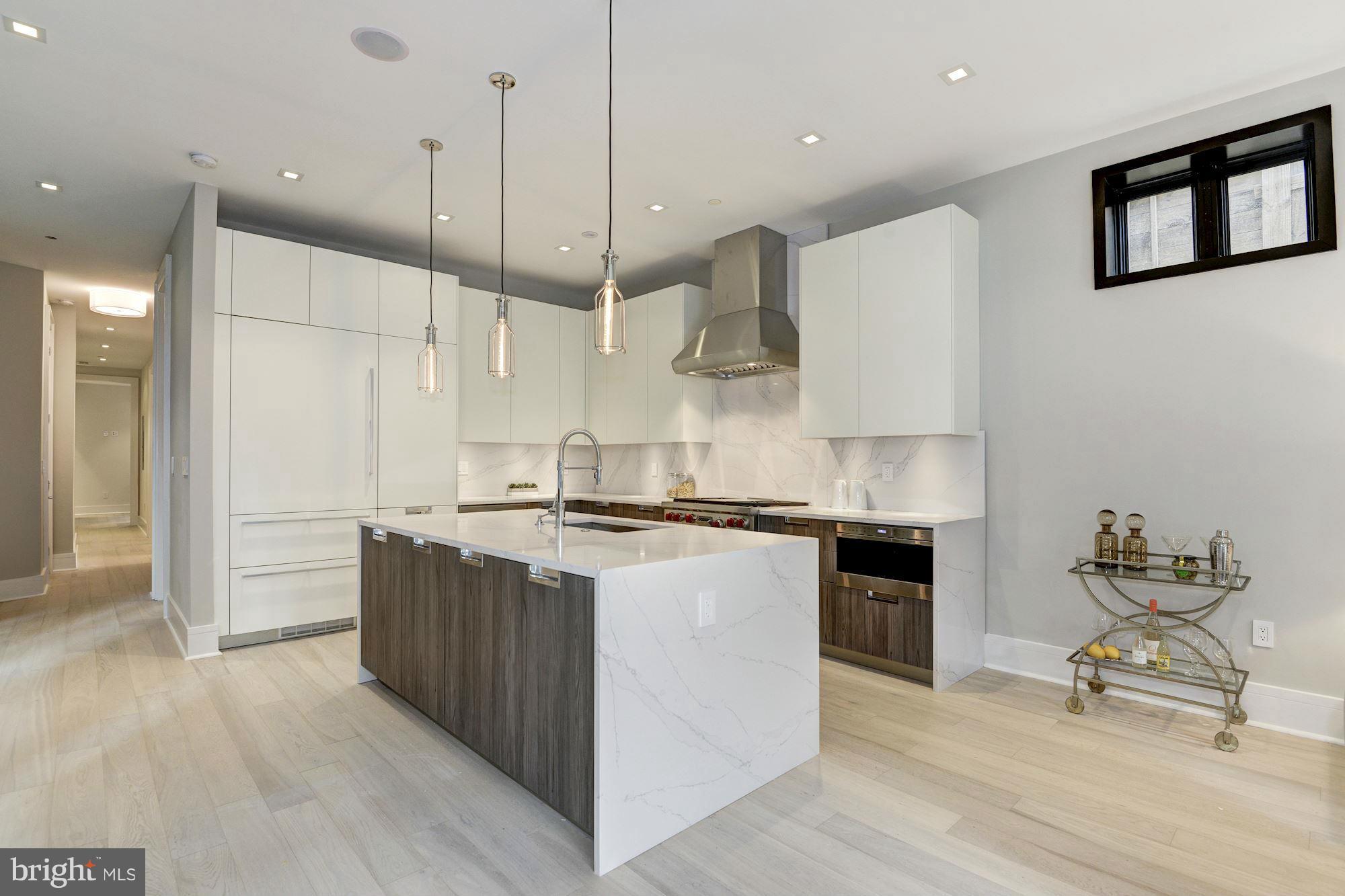1310 Q Street Northwest, Unit 4 Washington, DC 20009 - Photo 1 of 16 a kitchen with stainless steel appliances a stove a sink and a refrigerator