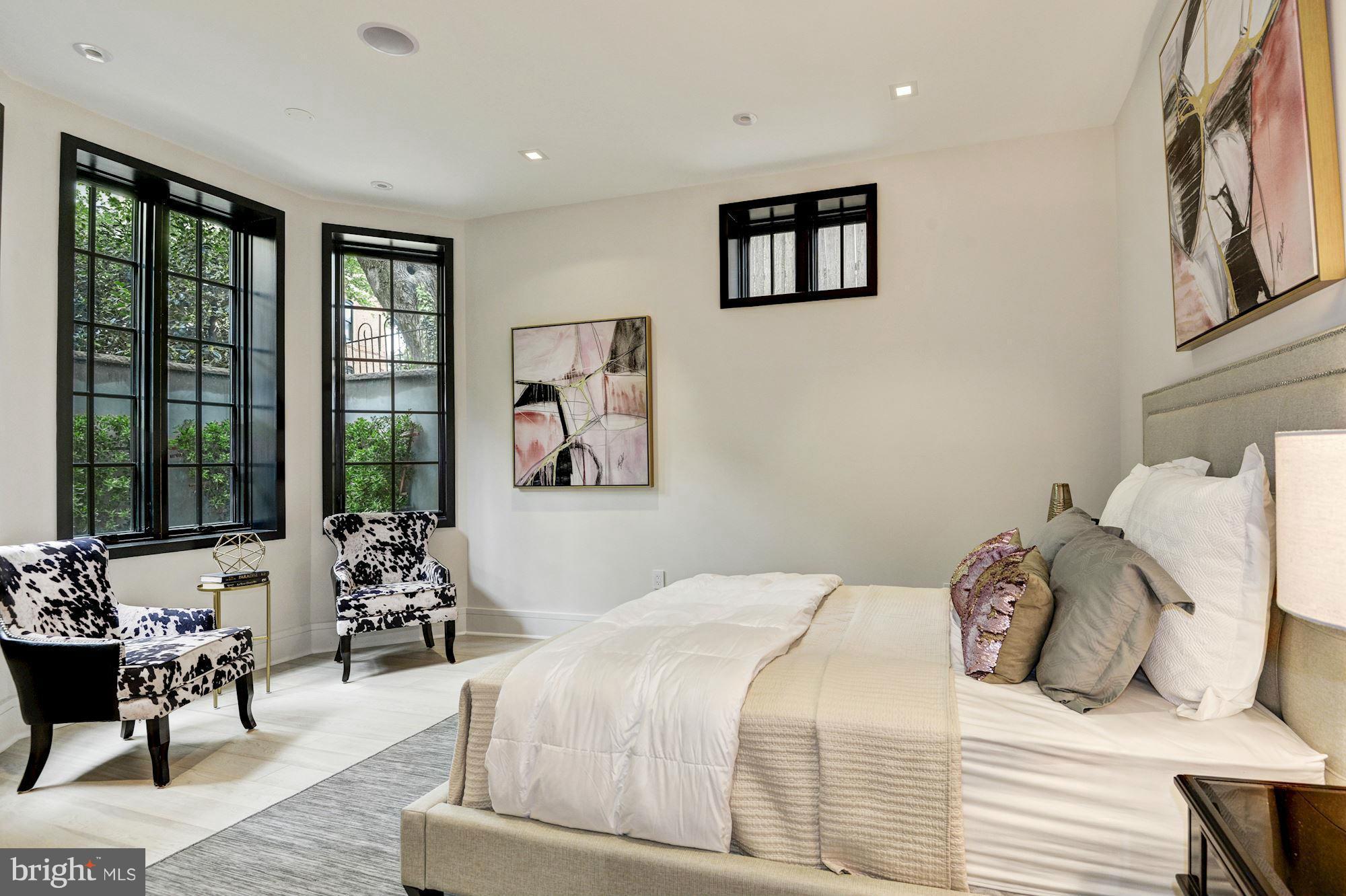 1310 Q Street Northwest, Unit 4 Washington, DC 20009 - Photo 8 of 16 a bedroom with a bed and wooden floor