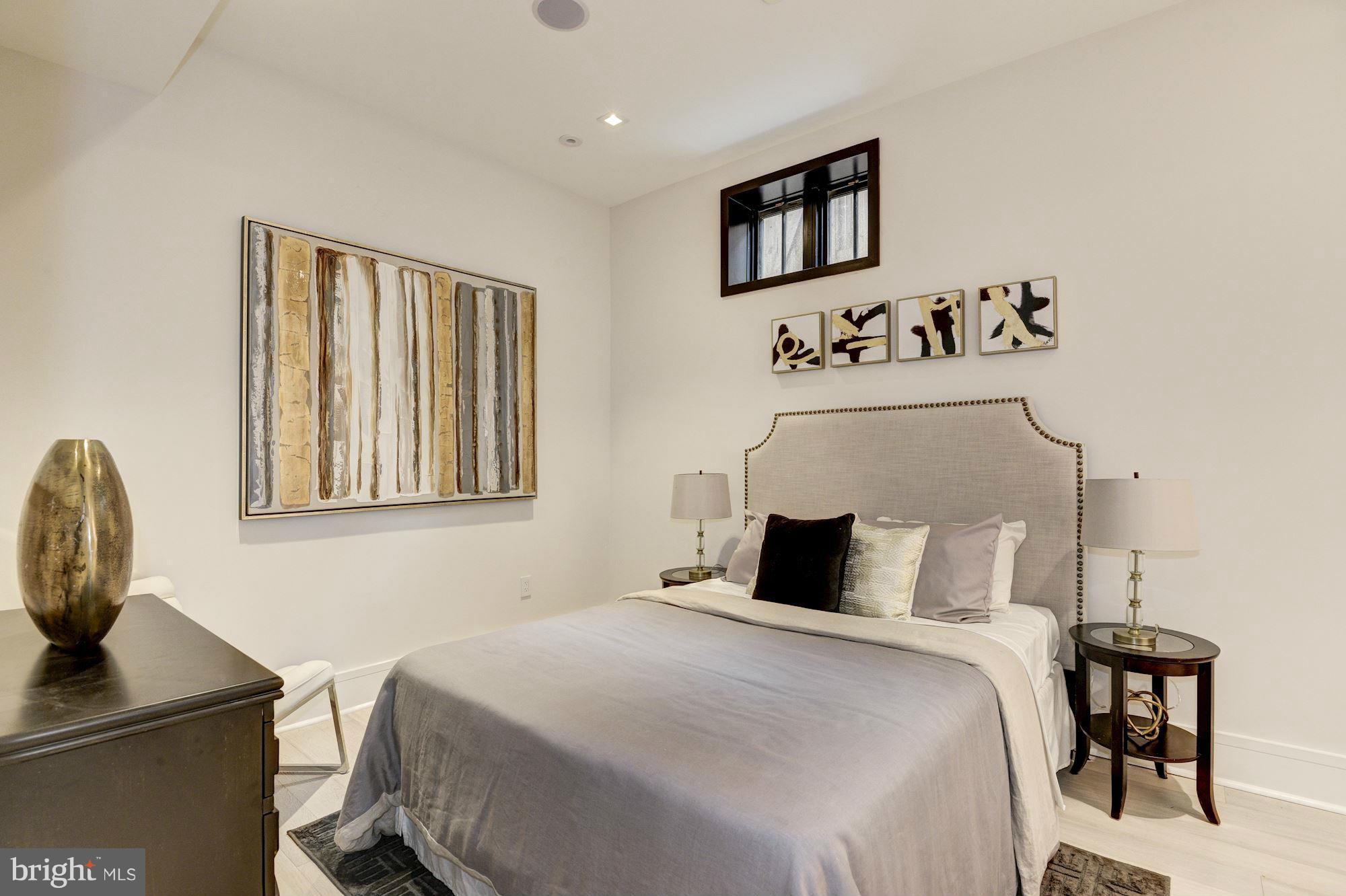 1310 Q Street Northwest, Unit 4 Washington, DC 20009 - Photo 10 of 16 a bedroom with a bed and painting on the wall