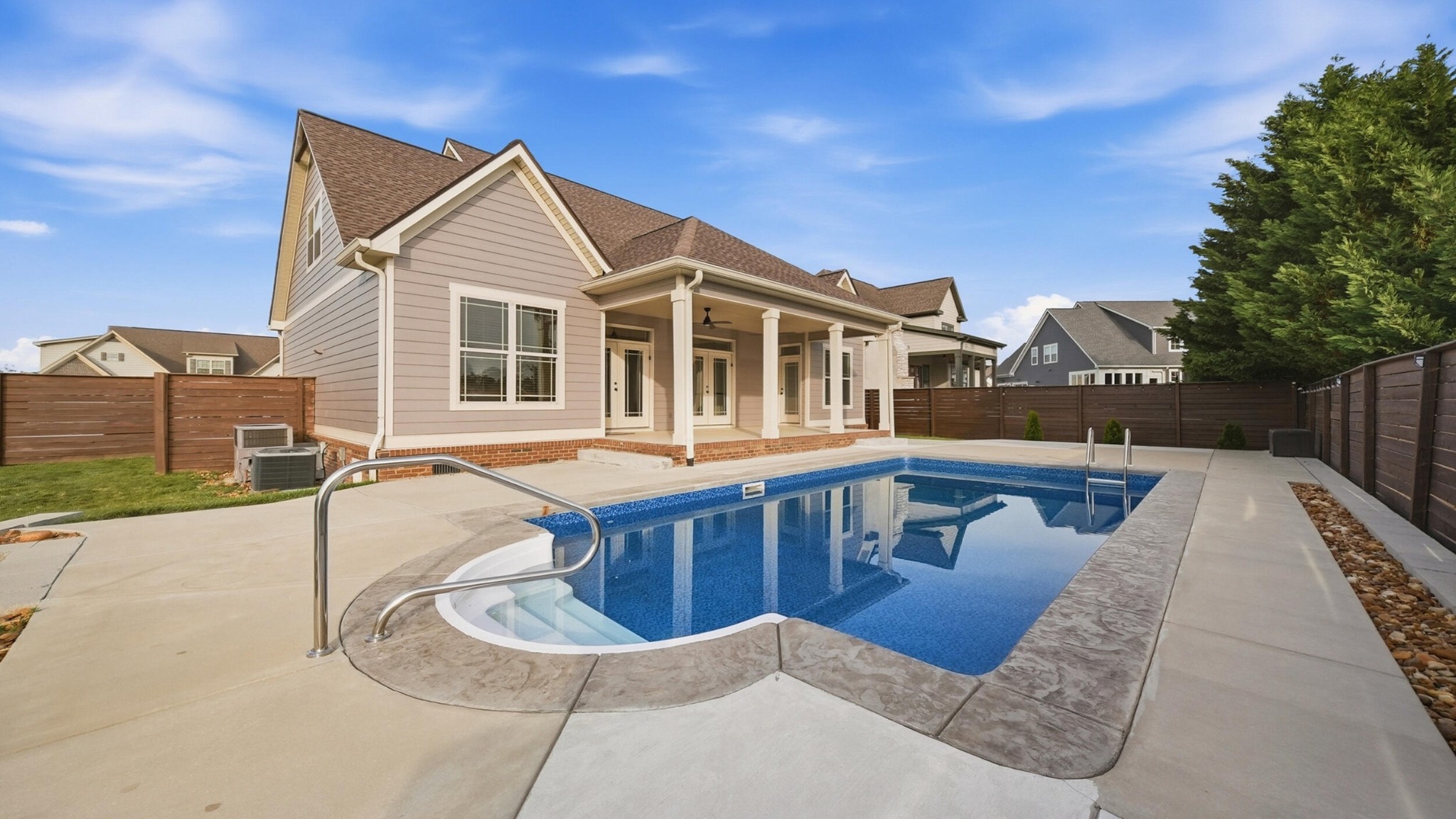 4046 Brock Road Chattanooga, TN 37421 - Photo 15 of 59 a view of a white house with a large pool and couches chairs
