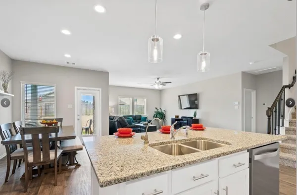 a kitchen with sink and view living room