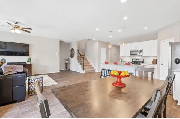 a living room with dining room and wooden floor