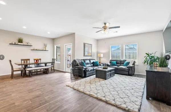 a living room with furniture and wooden floor