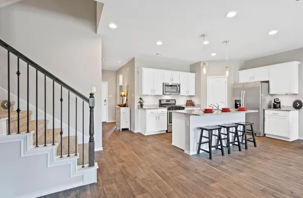 a kitchen with stainless steel appliances a refrigerator and a stove top oven