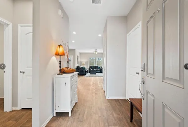 a view of kitchen and hall with wooden floor