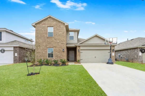 a front view of a house with a yard and garage