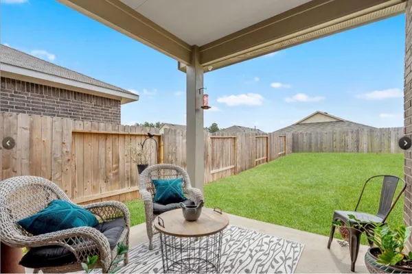 a backyard of a house with table and chairs