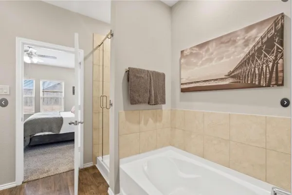 a bathroom with a tub and a shower