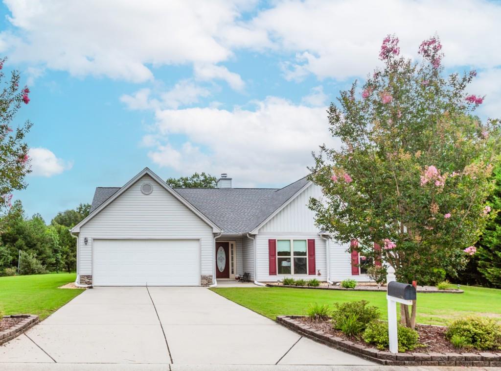 1411 Silvergate Way Winder, GA 30680 - Photo 1 of 38 a front view of a house with a yard and garage