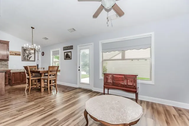 a living room with furniture and wooden floor