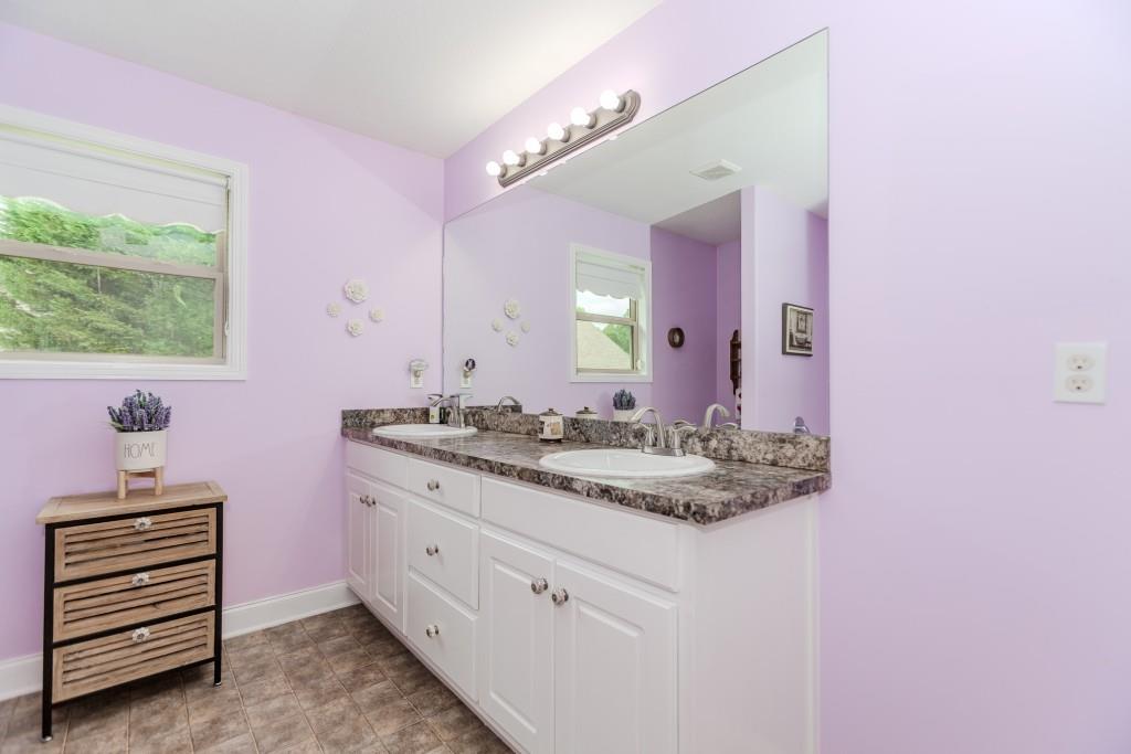 1411 Silvergate Way Winder, GA 30680 - Photo 24 of 38 a bathroom with a sink and a mirror