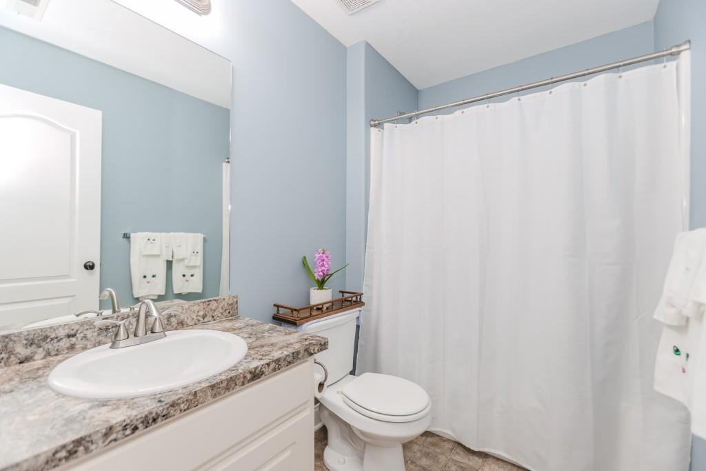1411 Silvergate Way Winder, GA 30680 - Photo 29 of 38 a bathroom with a granite countertop sink and a mirror