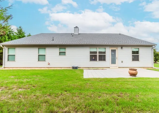 a front view of house with yard and seating area
