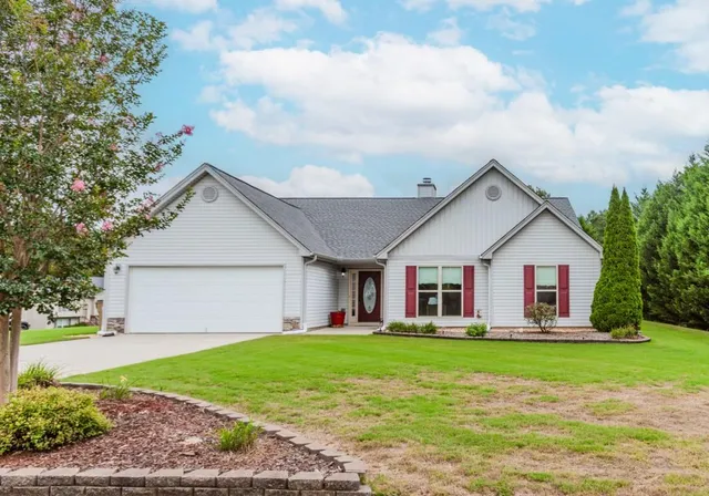 a front view of house with yard and green space