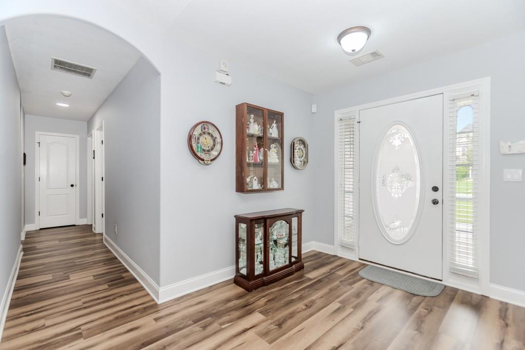 1411 Silvergate Way Winder, GA 30680 - Photo 8 of 38 a view of an empty room with wooden floor and a large window