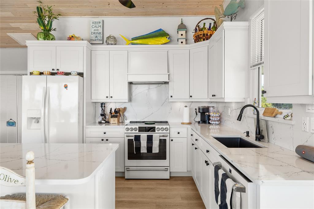 9712 Little Gasparilla Placida, FL 33946 - Photo 19 of 58 a kitchen with stainless steel appliances granite countertop a sink a stove and a refrigerator