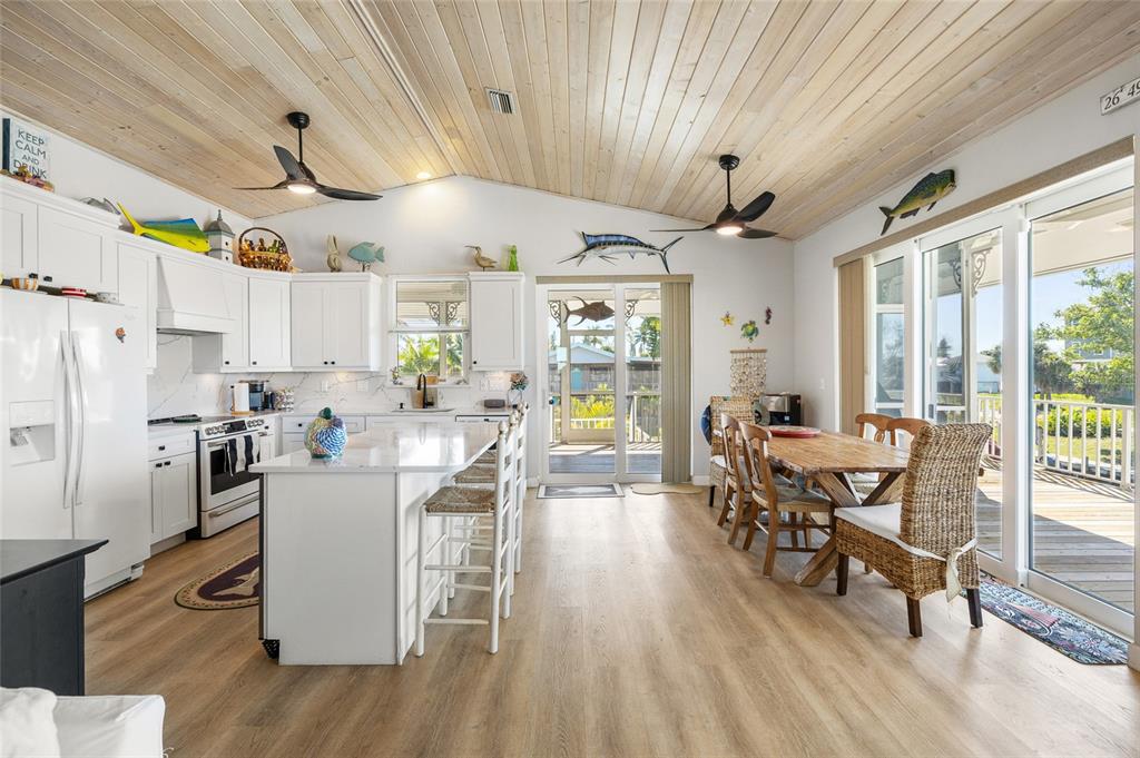 9712 Little Gasparilla Placida, FL 33946 - Photo 21 of 58 a view of a dining room with furniture window and wooden floor