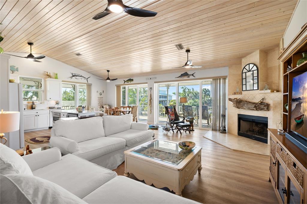 9712 Little Gasparilla Placida, FL 33946 - Photo 25 of 58 a living room with furniture a fireplace and a flat screen tv