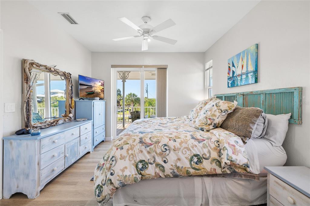 9712 Little Gasparilla Placida, FL 33946 - Photo 31 of 58 a bedroom with a large bed and a large window