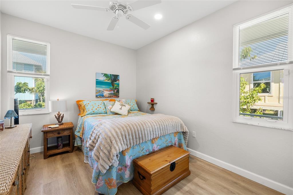 9712 Little Gasparilla Placida, FL 33946 - Photo 35 of 58 a bedroom with a bed and wooden floor