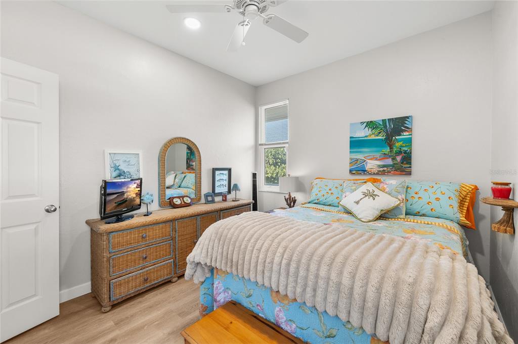 9712 Little Gasparilla Placida, FL 33946 - Photo 36 of 58 a bedroom with a bed and a dresser