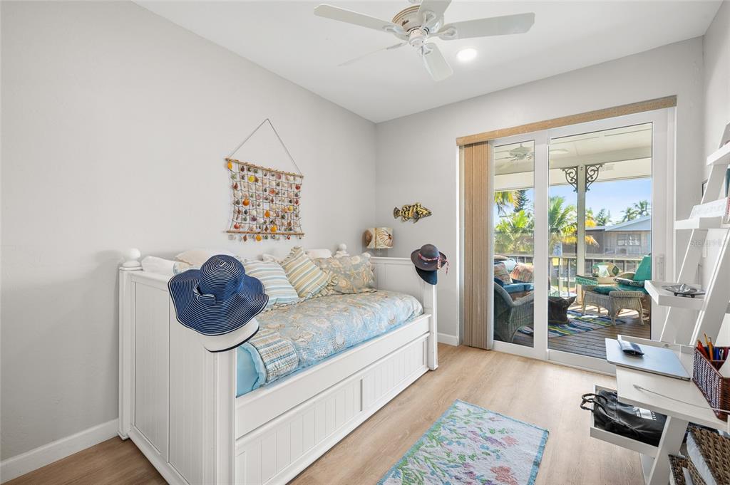 9712 Little Gasparilla Placida, FL 33946 - Photo 37 of 58 a bedroom with a bed and a chandelier