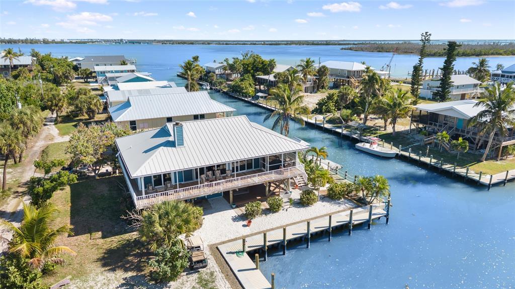 9712 Little Gasparilla Placida, FL 33946 - Photo 6 of 58 an aerial view of a house with a patio