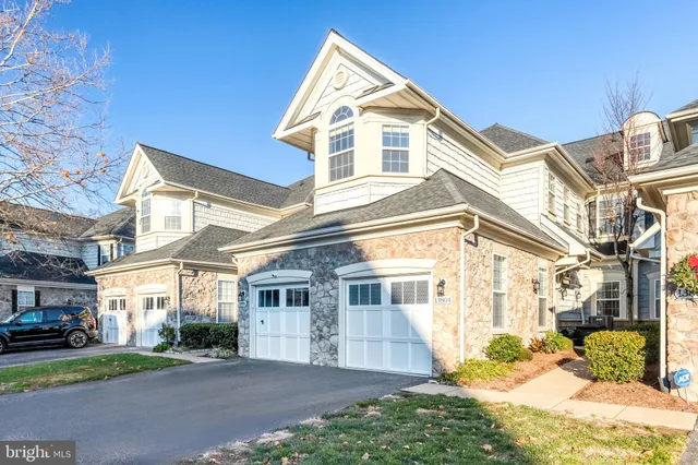 a view of a house with a yard and pathway