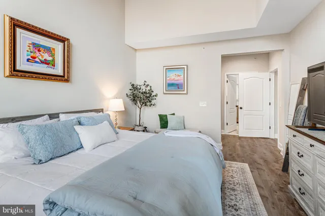 a bedroom with a large bed and a flat screen tv